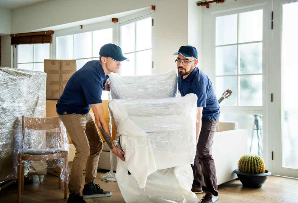 Professional movers carefully packing and moving valuable items in Dubai